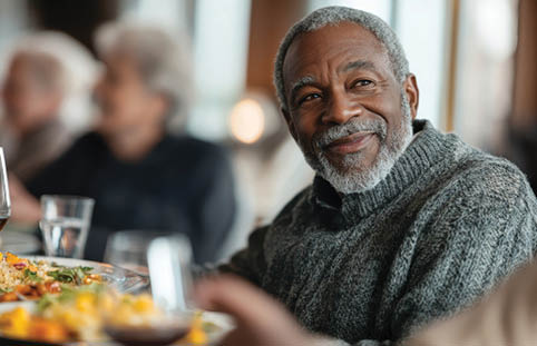 A man is sitting at a table with a plate of food in front of him. AI generated content
