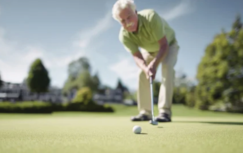 A man in a green shirt is playing golf on a green course. AI generated content